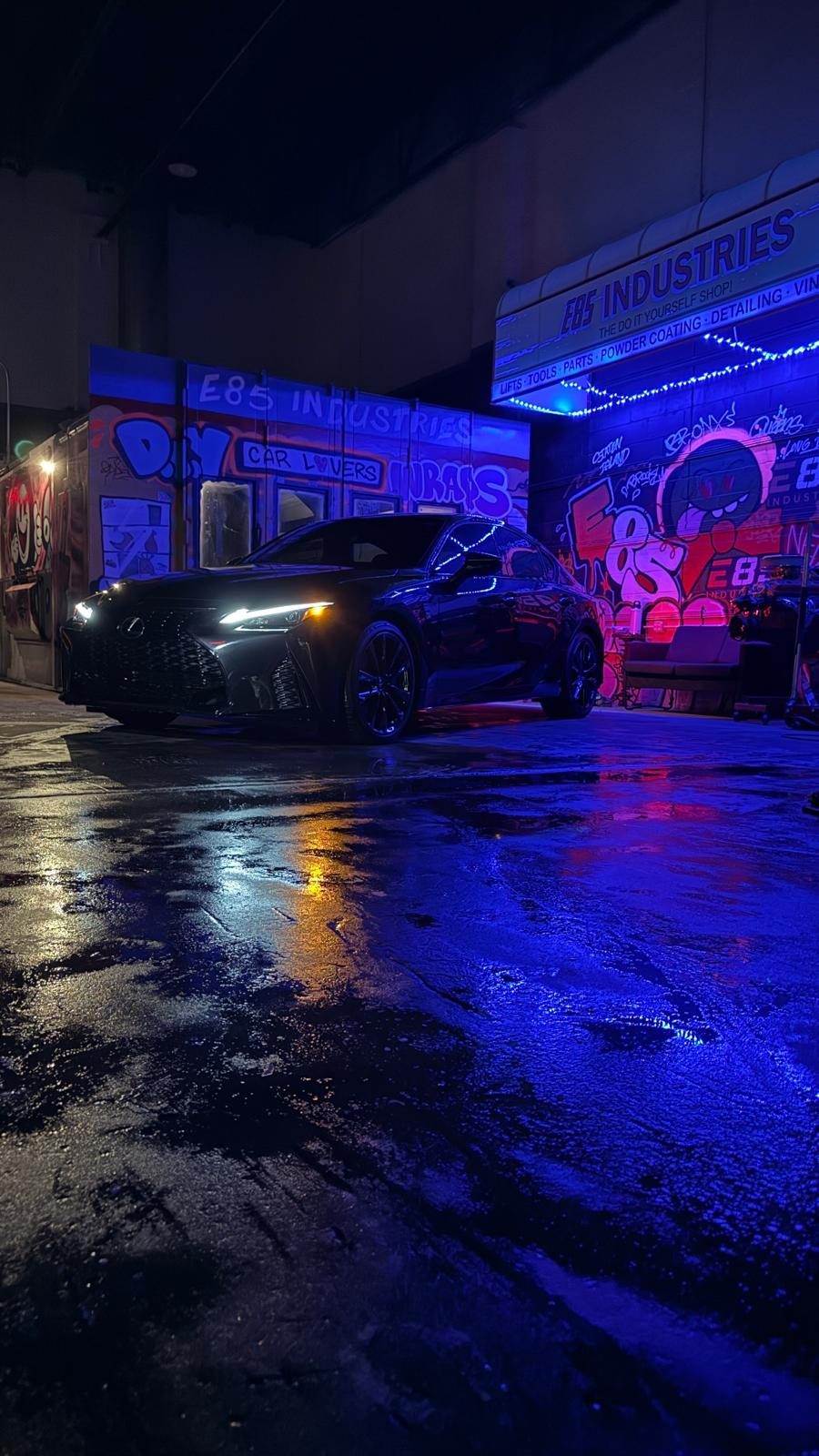 Lexus IS sedan at night after detailing