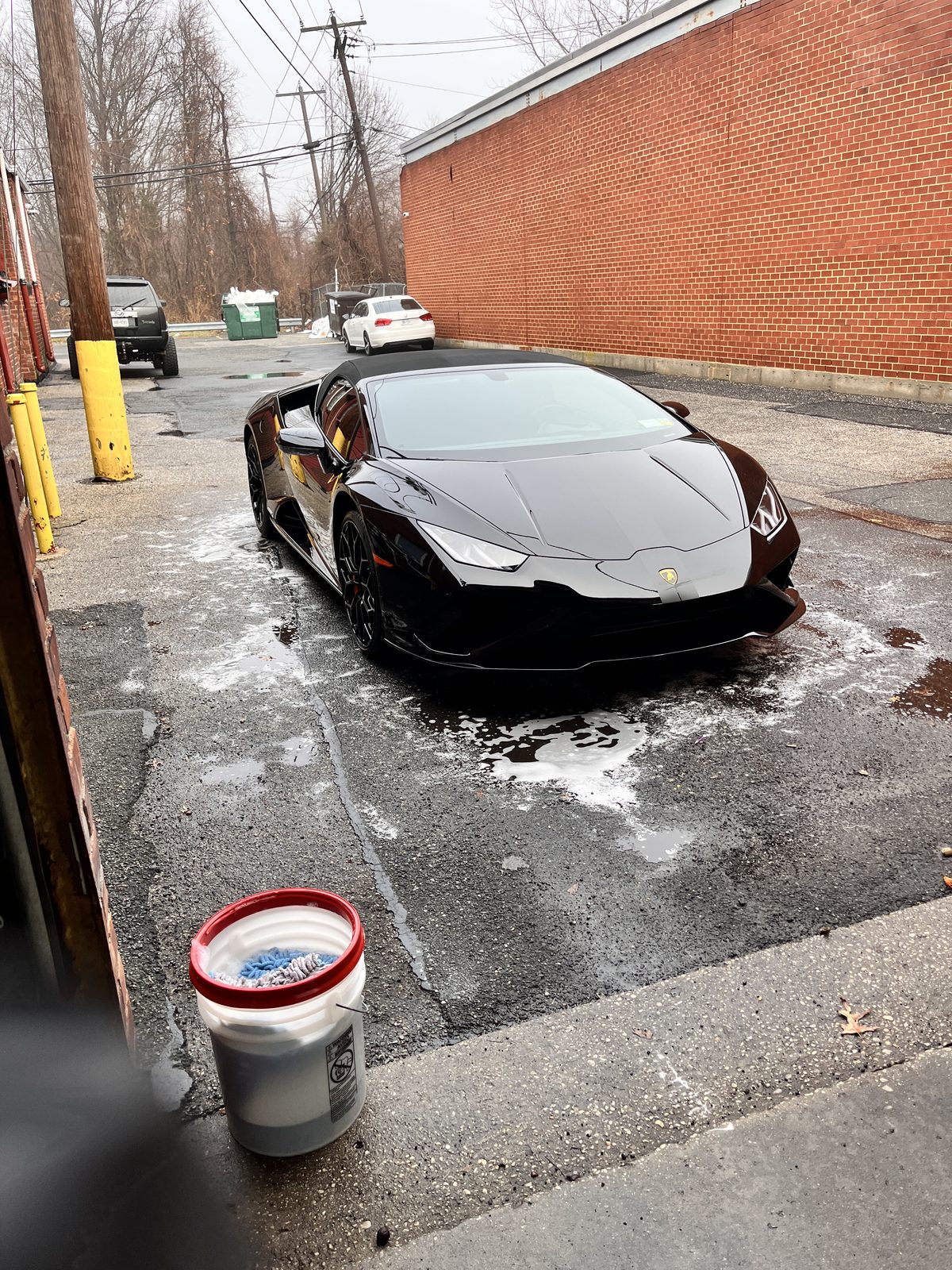 Black Lamborghini Huracan at detail bay